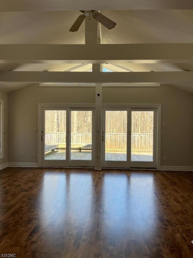 spare room with baseboards, lofted ceiling with beams, and plenty of natural light