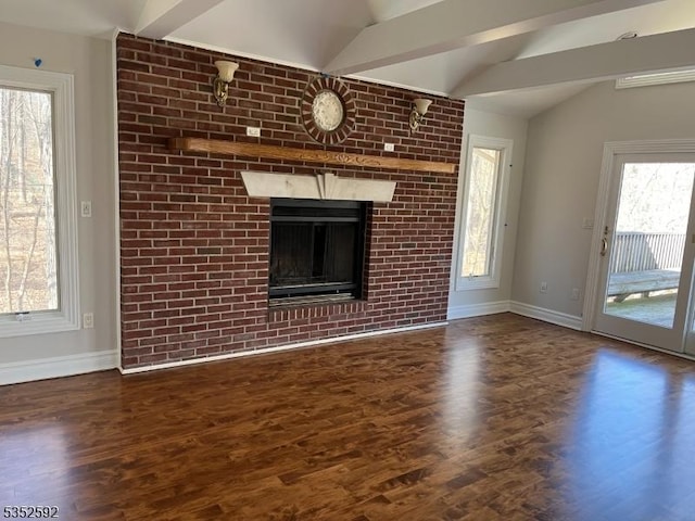 unfurnished living room with baseboards, lofted ceiling with beams, and wood finished floors