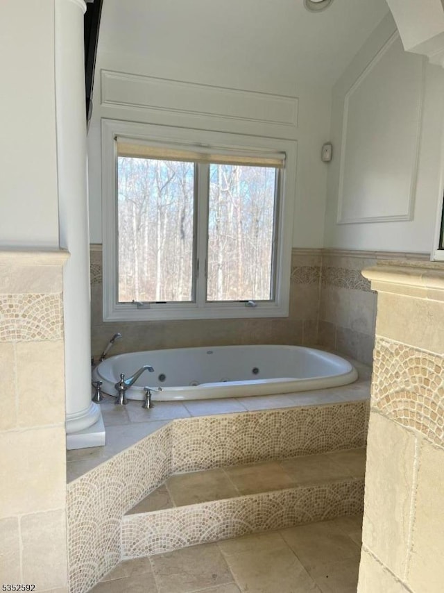 full bath with a jetted tub and tile patterned flooring