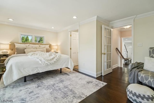 bedroom featuring dark wood-type flooring, recessed lighting, baseboards, and crown molding
