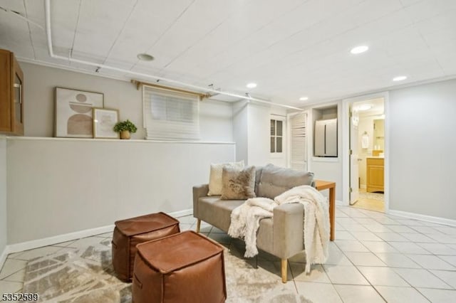 living room featuring recessed lighting, baseboards, and light tile patterned floors