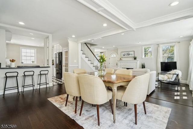 dining space featuring crown molding, recessed lighting, wood finished floors, and stairway