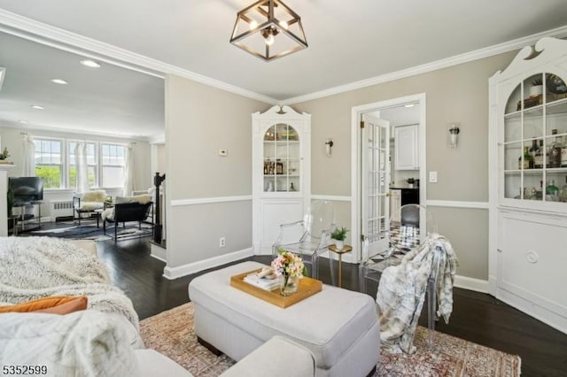 living room with baseboards, ornamental molding, and dark wood finished floors