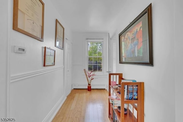 hall featuring a baseboard radiator and light wood-style floors