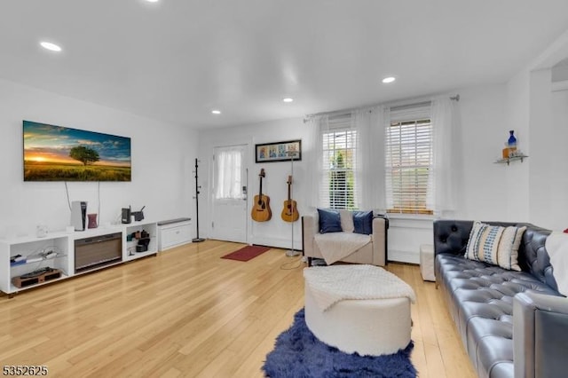 living area featuring light wood-style flooring and recessed lighting