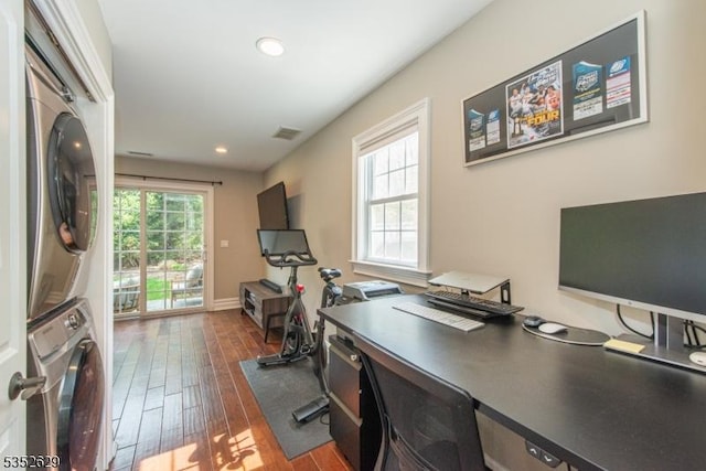 home office with recessed lighting, stacked washer and clothes dryer, dark wood-style floors, and visible vents