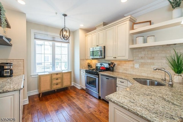 kitchen with open shelves, appliances with stainless steel finishes, a sink, baseboards, and dark wood-type flooring