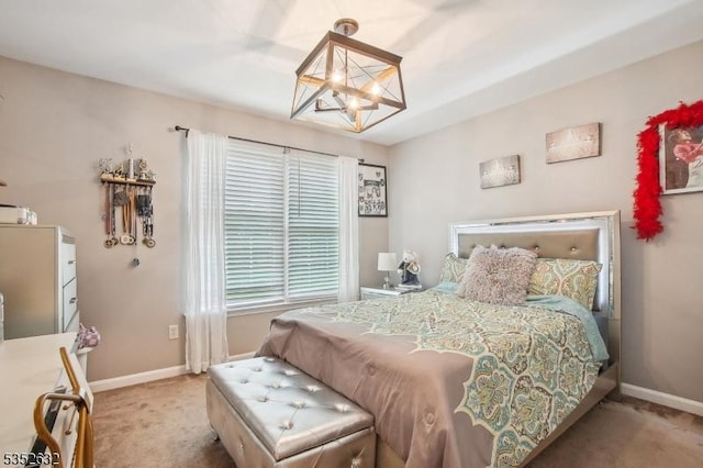 bedroom with a chandelier, carpet, and baseboards