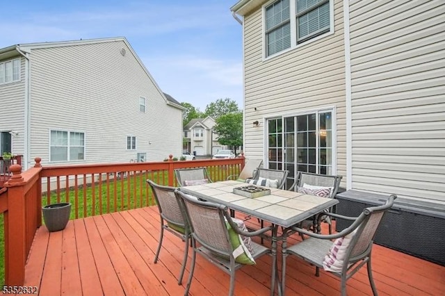wooden terrace featuring outdoor dining area