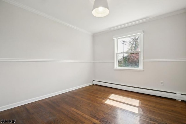 empty room featuring baseboards, ornamental molding, wood finished floors, and baseboard heating