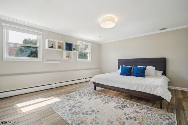 bedroom with crown molding, visible vents, baseboards, wood finished floors, and a baseboard heating unit