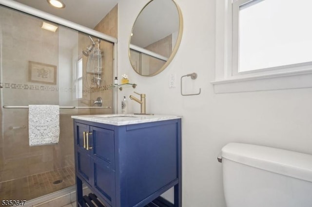 full bath featuring toilet, recessed lighting, a shower stall, and vanity