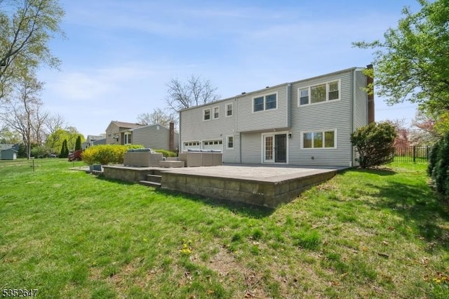 rear view of house featuring a patio area, fence, and a yard