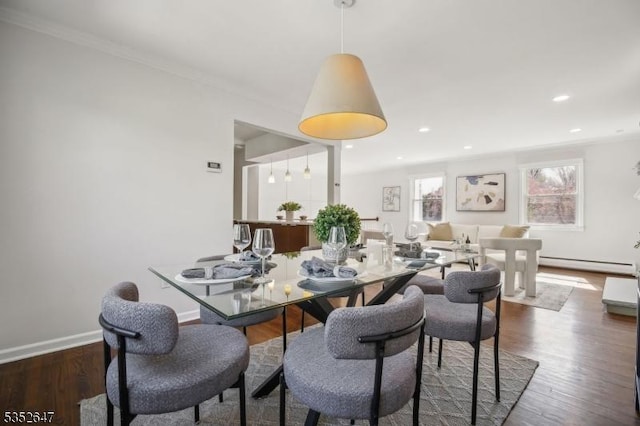 dining area featuring crown molding, wood finished floors, baseboards, recessed lighting, and a baseboard radiator