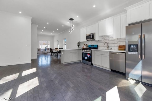 784 Valley St, Union Twp, NJ 07088 - kitchen with decorative backsplash, light countertops, dark wood finished floors, appliances with stainless steel finishes, and recessed lighting