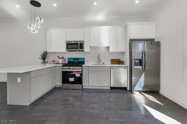 784 Valley St, Union Twp, NJ 07088 - kitchen with a peninsula, ornamental molding, stainless steel appliances, and a sink