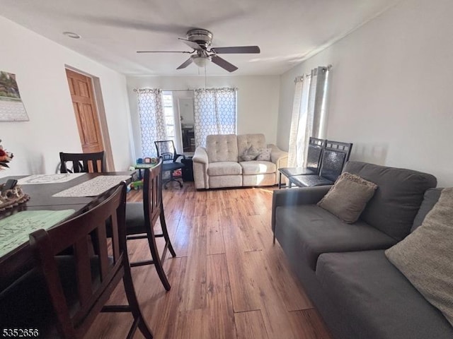 living area featuring hardwood / wood-style flooring and ceiling fan