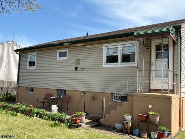 rear view of house with fence