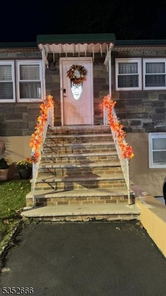 entrance to property featuring stone siding