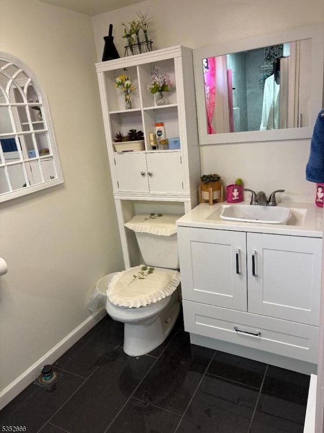 half bath with tile patterned flooring, vanity, and toilet