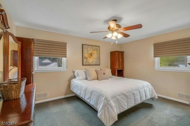 carpeted bedroom with ceiling fan, baseboards, and visible vents