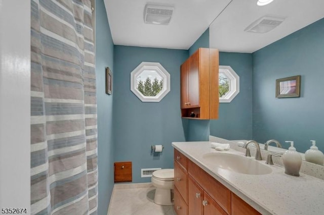 full bathroom with visible vents, toilet, vanity, and tile patterned floors