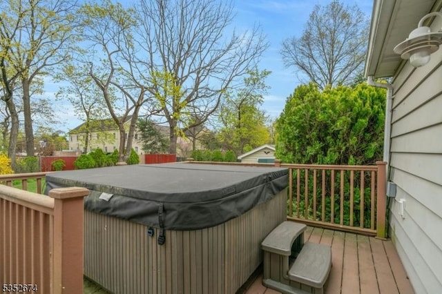 deck with fence and a hot tub