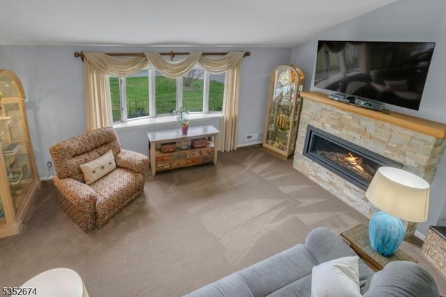 carpeted living room with a fireplace and baseboards