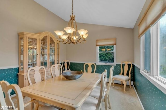 carpeted dining area featuring vaulted ceiling, baseboard heating, and an inviting chandelier