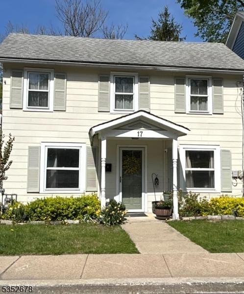 view of front of house with roof with shingles