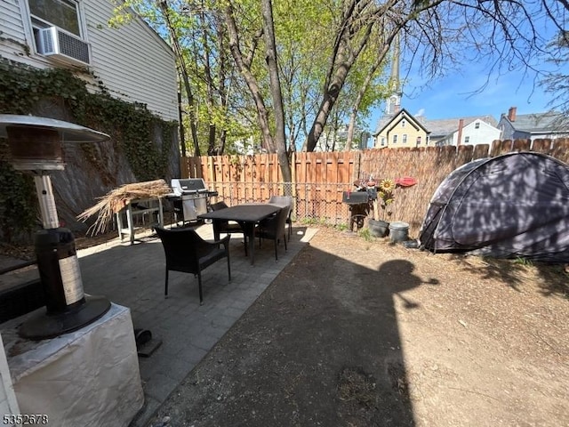 view of patio with a fenced backyard and outdoor dining area