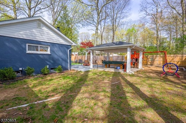 view of yard featuring a hot tub, a gazebo, a fenced backyard, and a patio area