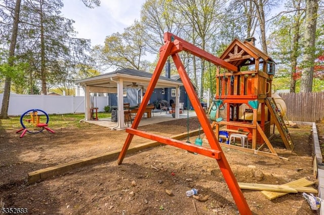 view of jungle gym featuring a fenced backyard, a ceiling fan, and a patio area