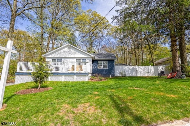 view of yard with fence and a wooden deck