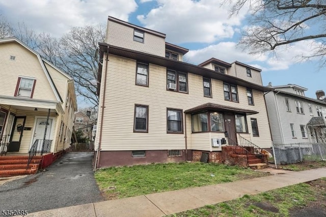 american foursquare style home with a front yard