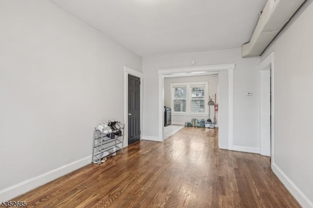 interior space featuring baseboards and wood finished floors