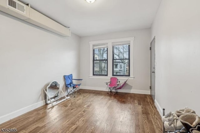 miscellaneous room featuring visible vents, baseboards, and wood finished floors