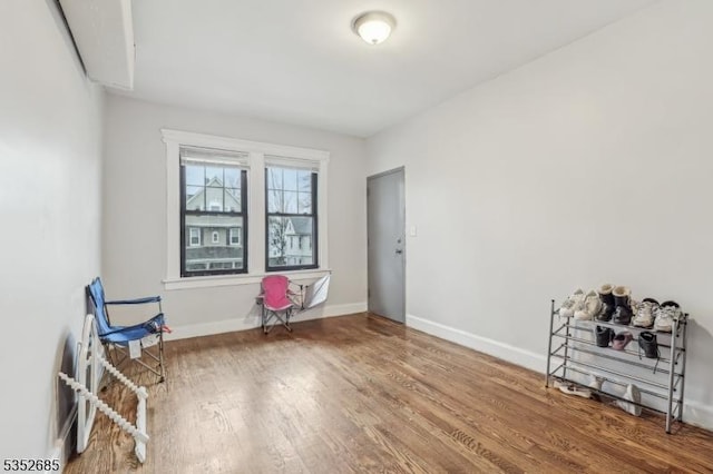 interior space with baseboards and wood finished floors