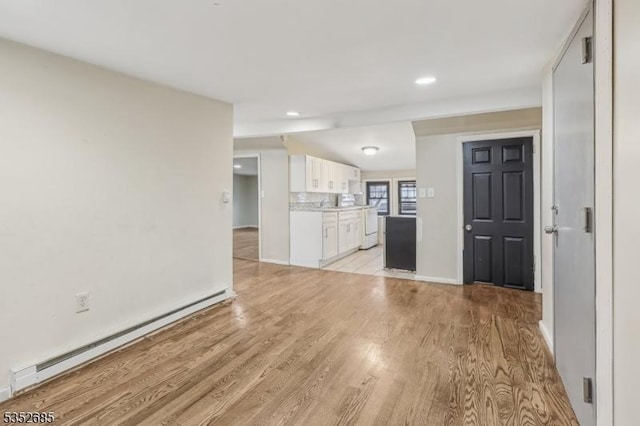 unfurnished living room with recessed lighting, baseboards, a baseboard heating unit, and light wood-style floors