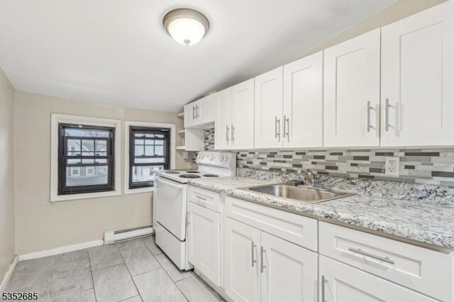 kitchen featuring white range with electric stovetop, a sink, baseboards, decorative backsplash, and a baseboard heating unit