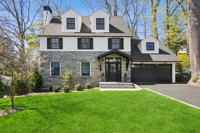view of front facade featuring a chimney, aphalt driveway, and stone siding