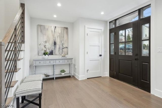 entrance foyer with recessed lighting, wood finished floors, and baseboards