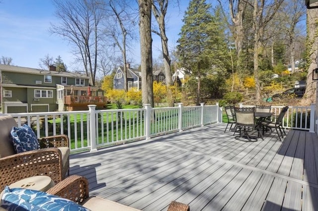 deck featuring outdoor dining area and a residential view