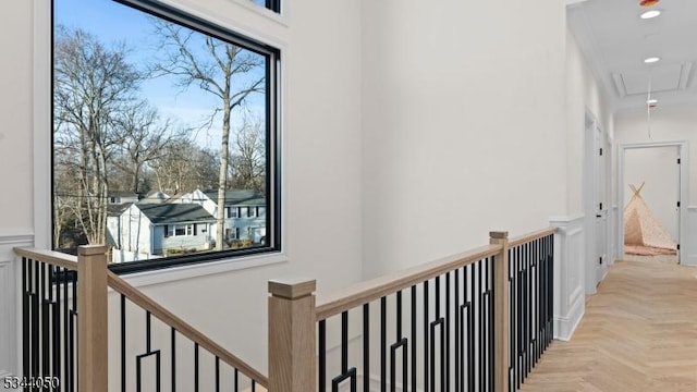hallway with attic access and an upstairs landing