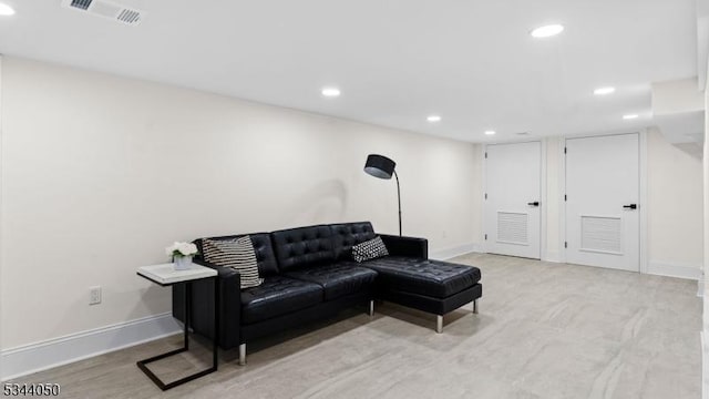living area featuring baseboards, visible vents, and recessed lighting