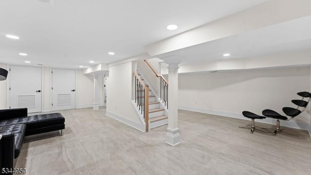 finished basement with recessed lighting, stairway, baseboards, and wood finished floors