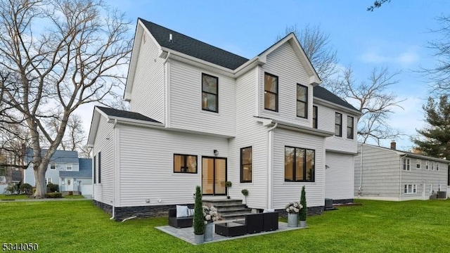 rear view of property with an outdoor living space and a yard