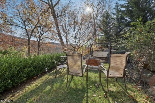 view of yard with a fire pit and a mountain view