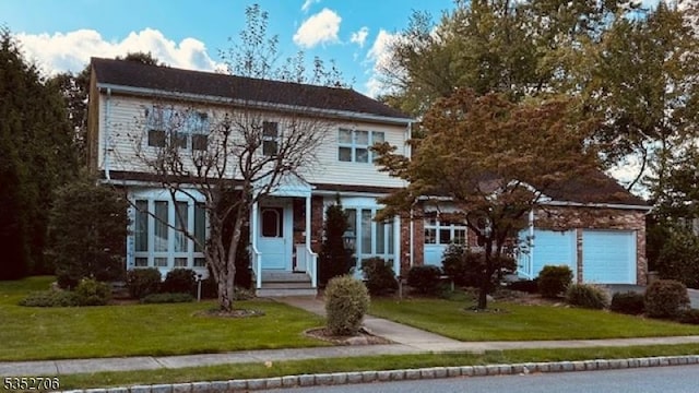 view of front of home featuring a garage and a front lawn
