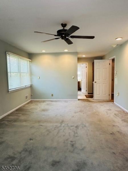 carpeted spare room with ceiling fan, baseboards, and recessed lighting